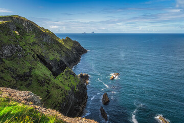 Tall Kerry Cliffs with a view on Great Skellig or Skellig Michael and Little Skellig islands where...