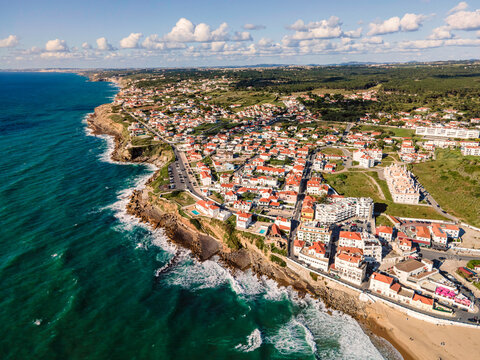 Aerial view of Praia das Macas little township along south Portuguese coastline facing the Atlantic Ocean, Colares, Portugal.
