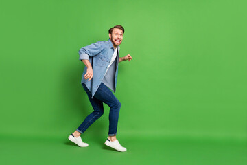 Full length body size photo of thief sneaking away looking back scared afraid stole something...