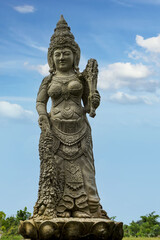 Statue of Buddhist Tara goddess against the sky - obrazy, fototapety, plakaty