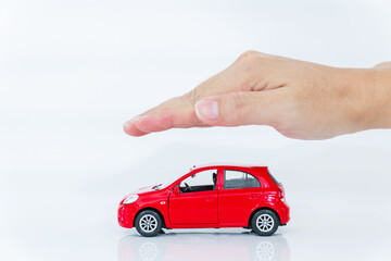 A Man with protective gesture small red car with man hand. Car (automobile) insurance and collision damage waiver concepts.