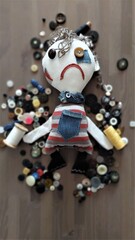 Rag doll, handicrafts, buttons instead of eyes. Stuffed, soft, light. Emotional doll. White with buttons. little boy. Frowning, angry.