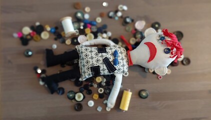 Rag doll, emotional rag doll, ZARPA -DODO. An emotional doll made of leftovers. A stuffed doll. He's got buttons instead of eyes. Soft and very strange. ON ONE SIDE HE SMILES FROM THE OTHER FROWNING. © Iveta