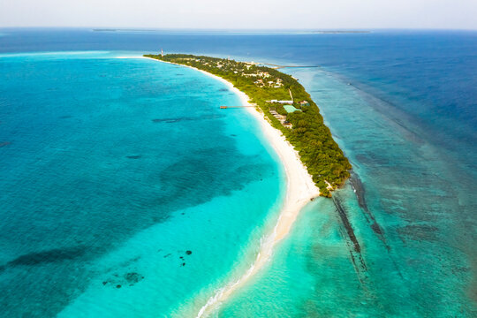 Panoramic aerial view of the local, inhabited island of Vashafaru with sandbank, Maldives.