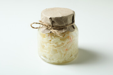 Glass jar of sauerkraut on white background