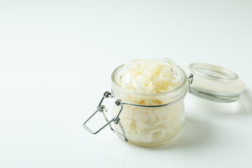 Glass jar of sauerkraut on white background