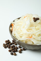 Bowl of sauerkraut on white background, close up