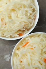 Bowls of sauerkraut on gray textured background