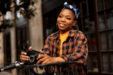 Attractive tourist with a camera. Beautiful woman with camera taking photos of beautiful location.