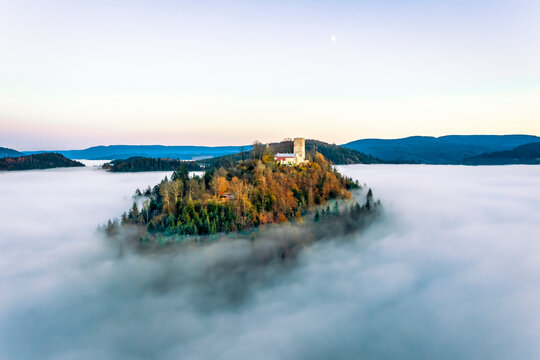 Panoramic aerial sunset view of the castle Yburg with floating fog in autumn, Varnhalt, Black Forest, Baden Baden, Baden Wine Route, Germany.