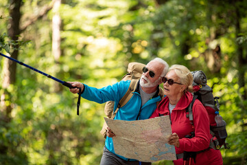 Senior couple looking for destination on the map