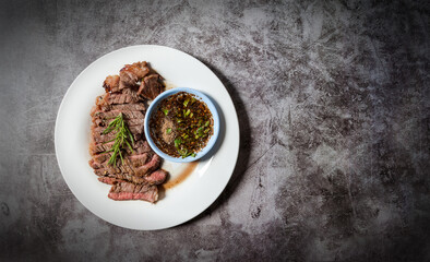 Grilled Beef Sirloin with Thai spicy sauce sirloin with copy space on dark tone background, Thai food, Thai style 