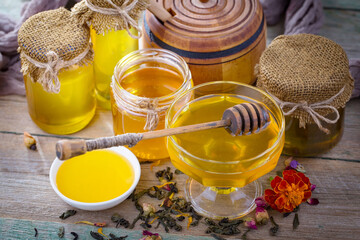 Sweet honey, with kitchen accessories in the composition on the table.