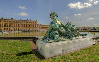 Fototapeta na wymiar Versailles, April 17th 2019 : Bronze sculpture in the garden of castle Versailles, France.