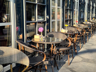 Empty tables of outdoor city cafe.