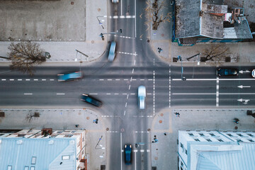 Aerial view of fast blurry cars traffic moving across crossroad in Kaunas city, Lithuania.