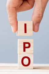 IPO (Initial Public Offering) word with wooden cube block, shares of a private corporation to the...