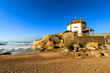 Fototapeta na wymiar Beautiful chapel in the sea called Senhor da Pedra in Porto