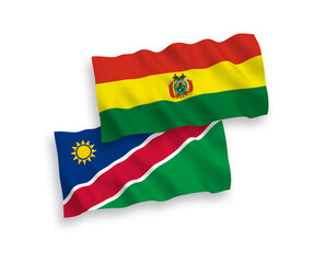 National vector fabric wave flags of Republic of Namibia and Bolivia isolated on white background. 1 to 2 proportion.