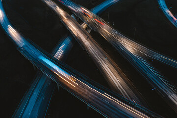 Aerial view of busy and fast highway traffic lights at night in Kaunas, Lithuania.