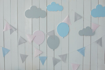 Stylish children room with hanging cotton flags. Decoration for baby room. Babyshower party. Kid Holiday. White wall is decorated with multi-colored garland of flags and air ballons. Decor for holiday © stock_studio