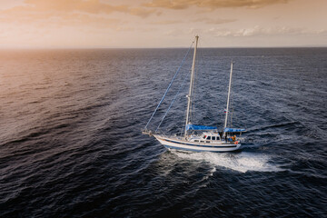 Aerial view of a sailing boat navigating along Vladivostok shore in Amurskiy Zaliv sea, Vladivostok, Russia.