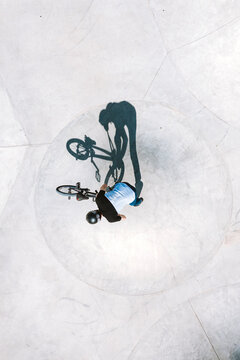 Aerial view of BMX bike rider silhouette shadow looking like monster creature, Panevezys, Lithuania.