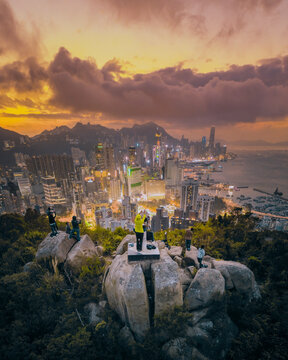 Hong Kong - 14 February 2019: Aerial view of people shooting photographs to the city skyline at sunset, Hong Kong.