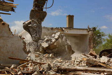 Tracked excavator demolishing old buildings