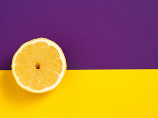 Yellow juicy lemon on a bright solid background. The citrus is in the middle. Horizontal orientation