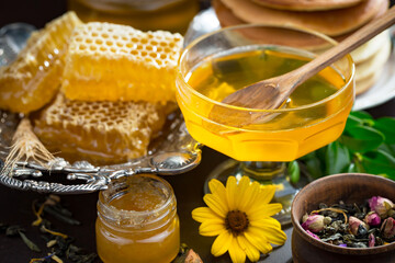 Sweet honey, with kitchen accessories in the composition on the table.