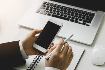Close-up view of businesswoman searching for important information on smartphone for her current project