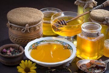 Sweet honey with flowers on an old background.