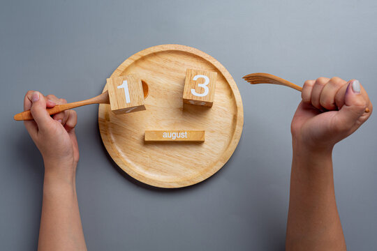 Left handed person holding the spoon on left side.Left hander day concept.