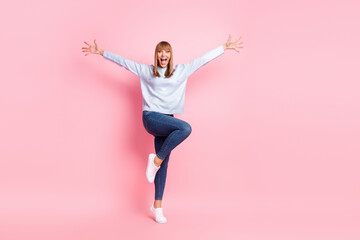 Full length body size view of pretty funnhy cheerful girl having fun jumping isolated over pink pastel color background