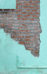 Dirty old painted wall with bricks background
