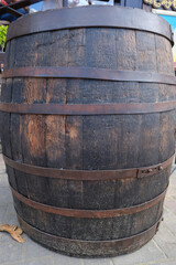 Brown old wooden barrel with wine. Selective focus