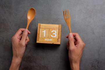 Left handed person holding the spoon on left side.Left hander day concept.