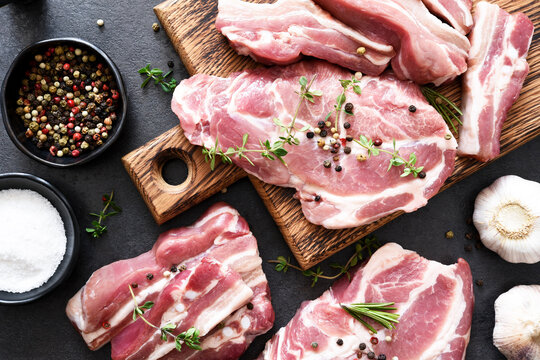 Fresh Raw Meat. Steak, Ribs With Spices On A Black Background. View From Above.