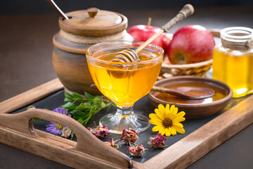 Sweet honey with flowers on an old background.