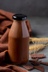 Glass of chocolate milk on the dark background.