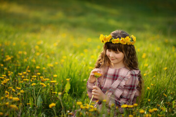 Naklejka na ściany i meble Photo of a girl with long hair in yellow flowers.