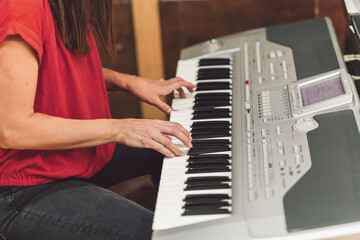 Woman playing the electronic piano