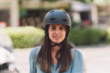 Portrait of a young woman wearing a bicycle helmet outdoors