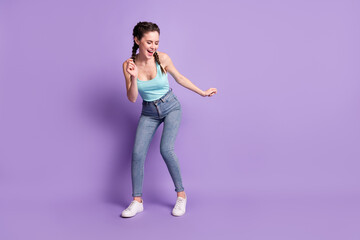 Fototapeta na wymiar Full length body size photo of dancing woman wearing casual clothes isolated on pastel violet color background with blank space