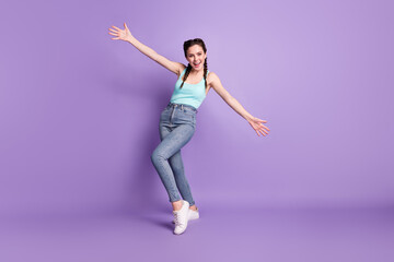 Full length body size view of attractive cheerful friendly girl dancing enjoying having fun isolated over violet purple color background