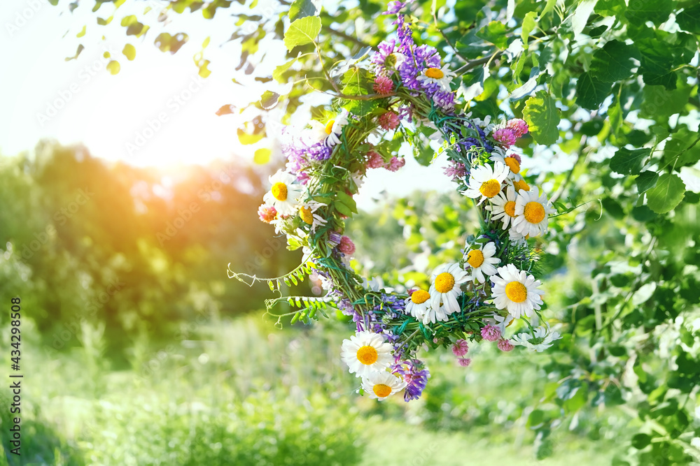 Wall mural wreath of wild meadow flower in summer garden. summer solstice day, midsummer concept. floral tradit