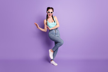 Full length body size view of attractive cheerful ecstatic girl dancing rest good mood isolated over violet purple color background