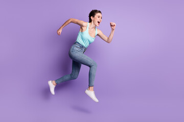Fototapeta na wymiar Full length body size profile side view of attractive cheerful girl jumping running isolated over violet purple color background