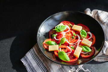 summer tomato salad veggie vegetable, cheese, onion diet vitamin on the table healthy food meal snack copy space food background rustic. top view vegan or vegetarian food